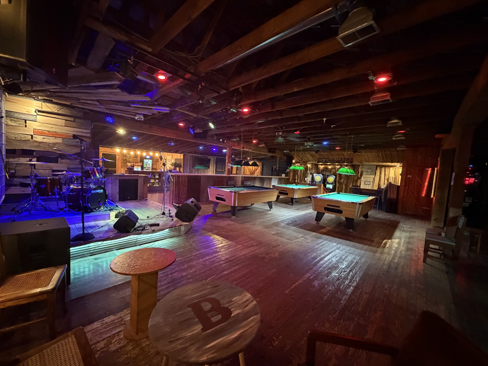 Wide view of Backbeat showing the stage, seating, and pool tables